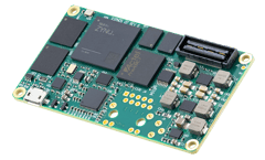 A compact green circuit board Q7 Processor featuring a large "Xilinx Zynq" chip, several smaller chips, and connectors, presented on a light grey surface.