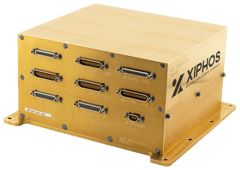 A golden-colored, rectangular metal box Q8 On Board Computer with multiple rows of D-sub connectors on one side, and "Xiphos" logo printed on the right.